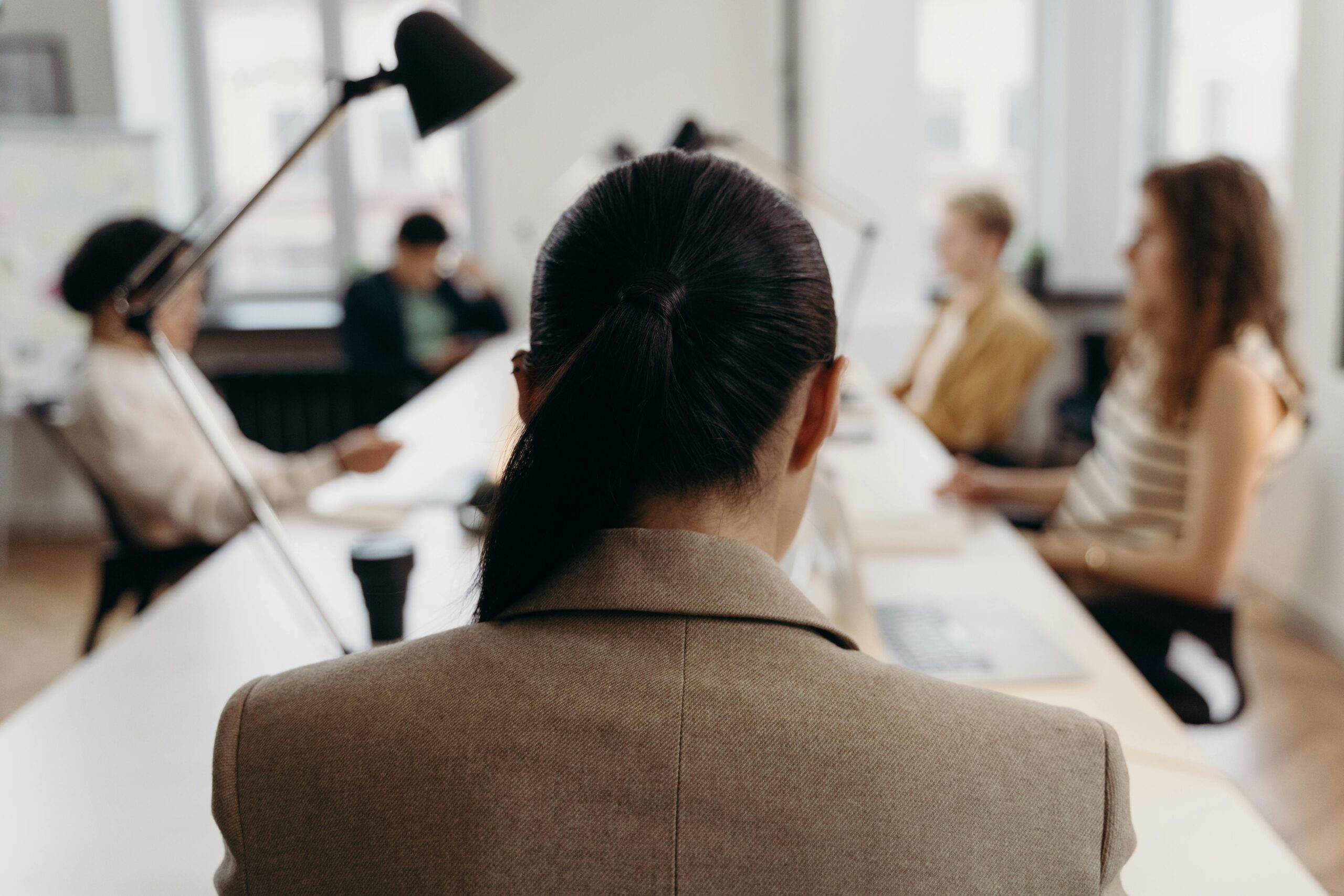 Diverse professionals collaborating in a modern office space, focused on teamwork and project management.